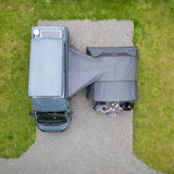 Aerial view of the Vango Cove III awning pitched beside a campervan