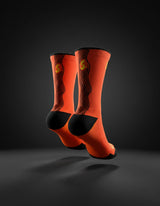 Rear view of Stride Heat Surge running socks on a dark background, showing the black heel and back stripes
