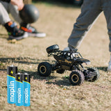 Remote-controlled toy car on grass beside Maplin batteries