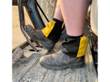 Yellow and black harlequin sox savers worn over dealer boots