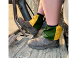 Dark green and yellow harlequin sox savers worn over work boots in a cab