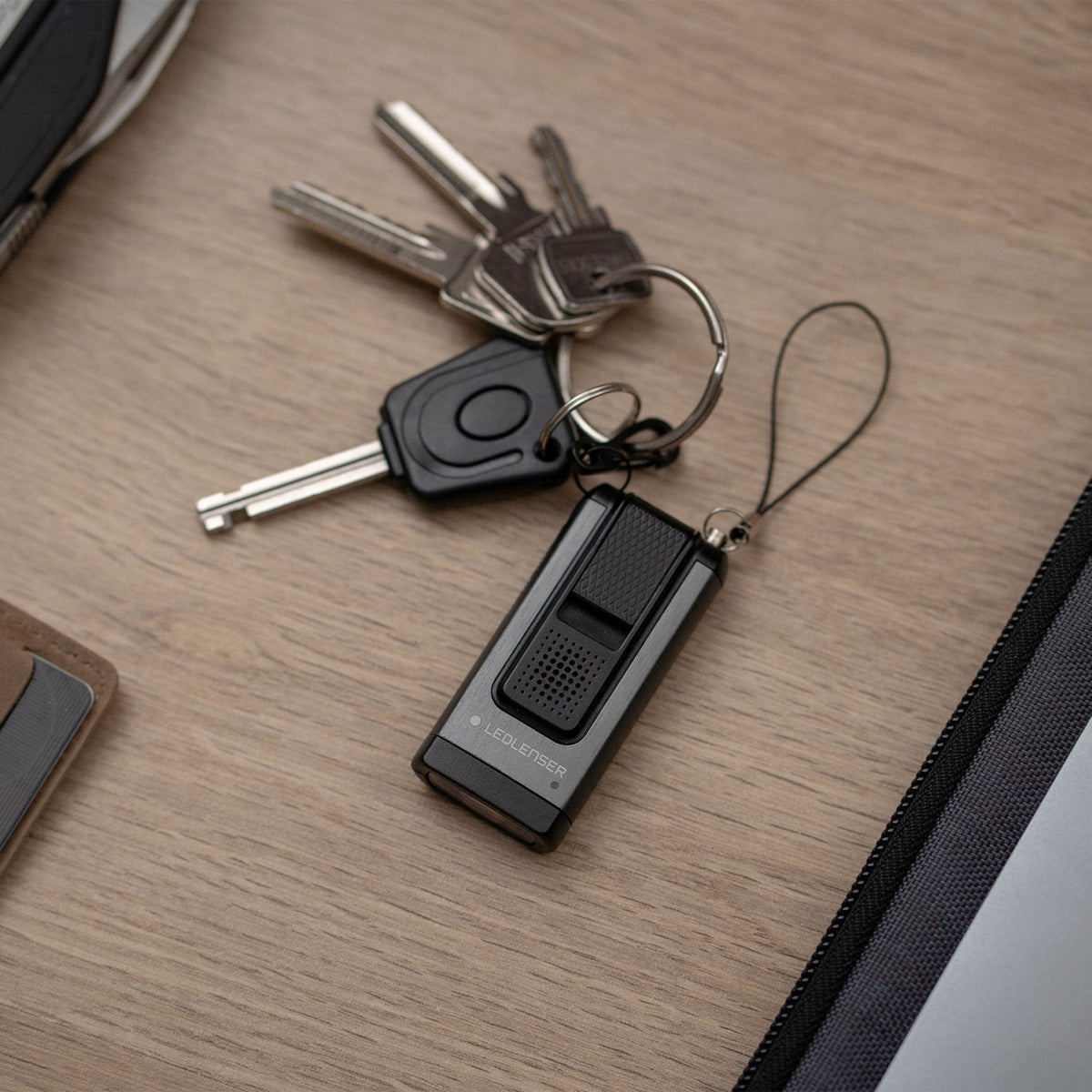 Ledlenser K6R Safety on a key ring on a wooden desk