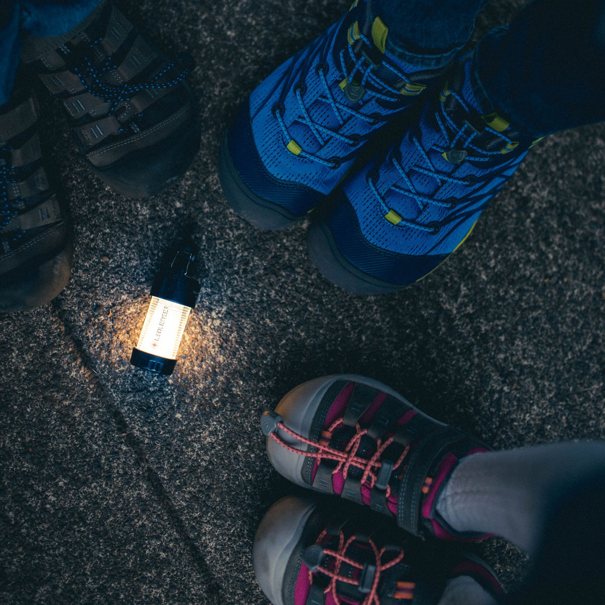 Ledlenser ML4 lighting the ground between walkers' boots at night