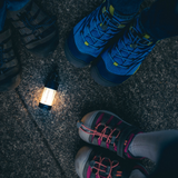 Ledlenser ML4 lighting the ground between walkers' boots at night