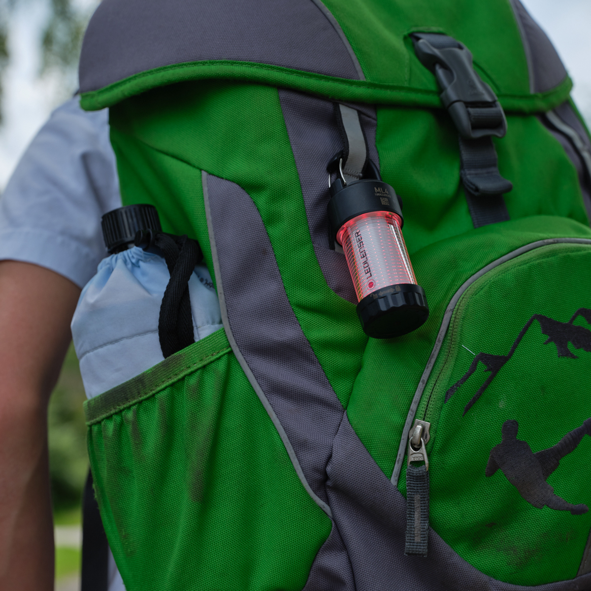 Ledlenser ML4 mini lantern clipped to a green rucksack strap