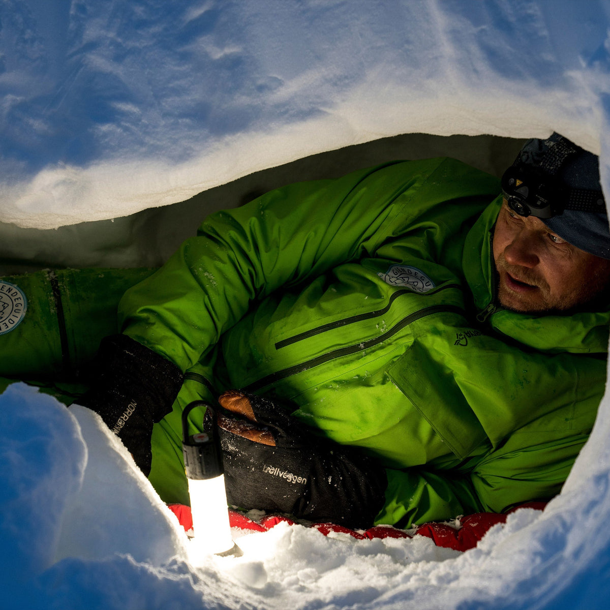 Man in a snow hole lit by the Ledlenser ML6 lantern