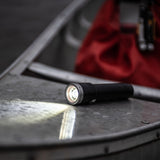 Ledlenser MT torch lighting the wet deck of a canoe