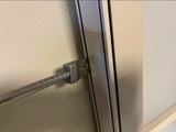 Wedge claw of the 8 in Titanium Hooligan Bar set in a door frame gap