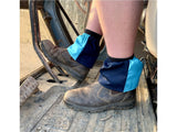 Navy and sky blue harlequin sox savers worn over boots in a tractor footwell