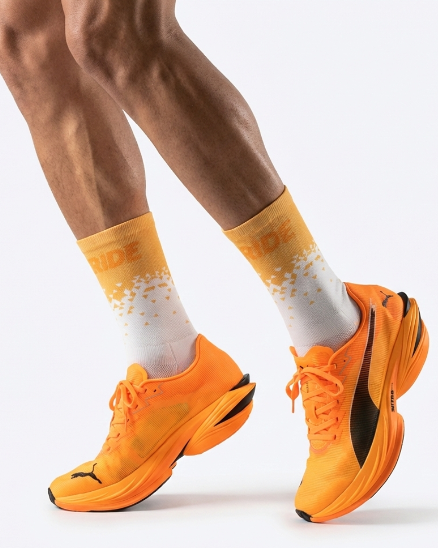 Runner's lower legs in Stride Tropic Tempo half crew running socks with orange running shoes
