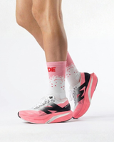 Runner's lower legs in Stride Flash Pink half crew running socks with pink and white running shoes
