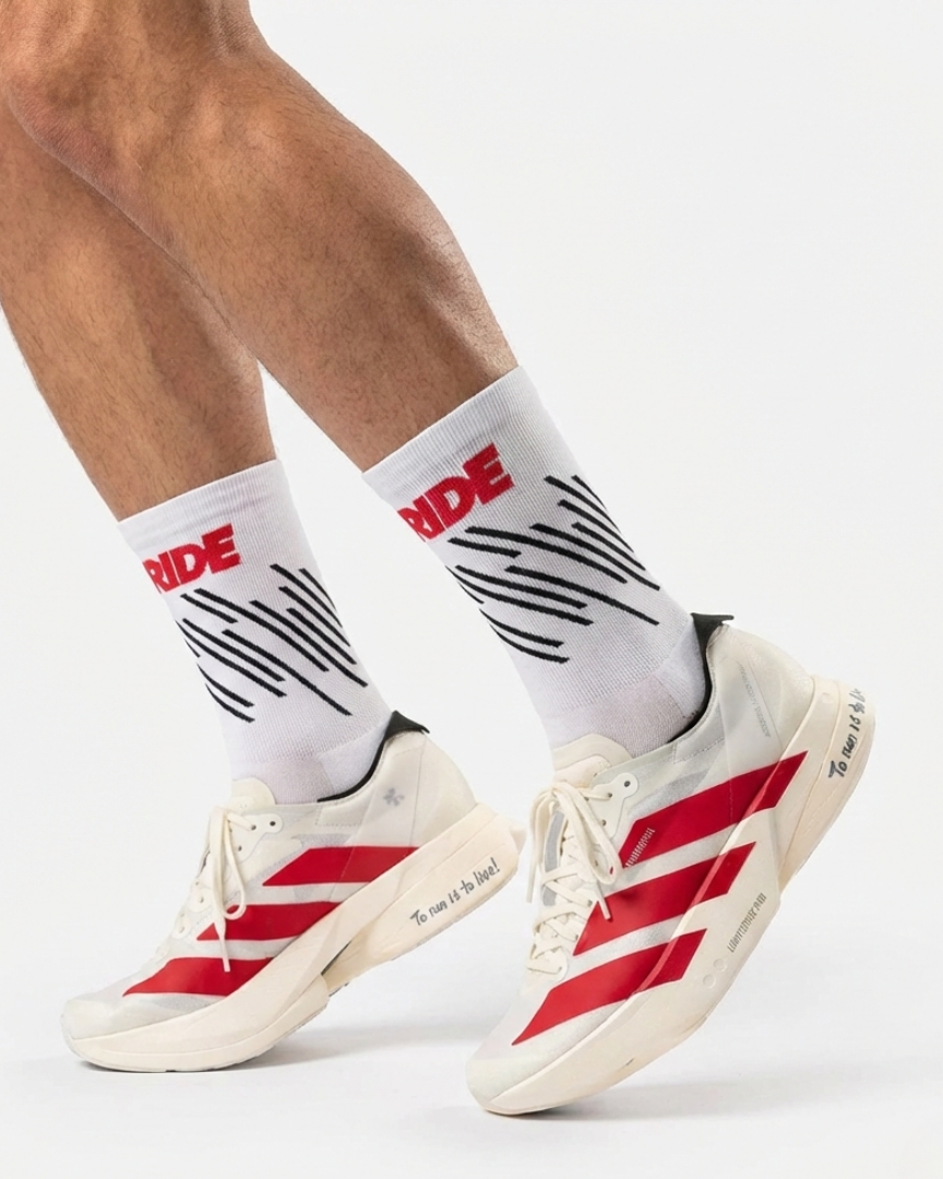 Runner's lower legs in Stride Race Core half crew running socks with white and red running shoes