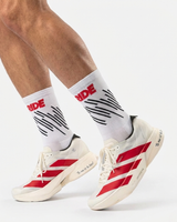 Runner's lower legs in Stride Race Core half crew running socks with white and red running shoes