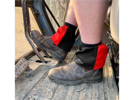 Black and red harlequin sox savers worn over dealer boots on a tractor step