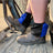 Black and royal blue harlequin sox savers worn over work boots in a cab