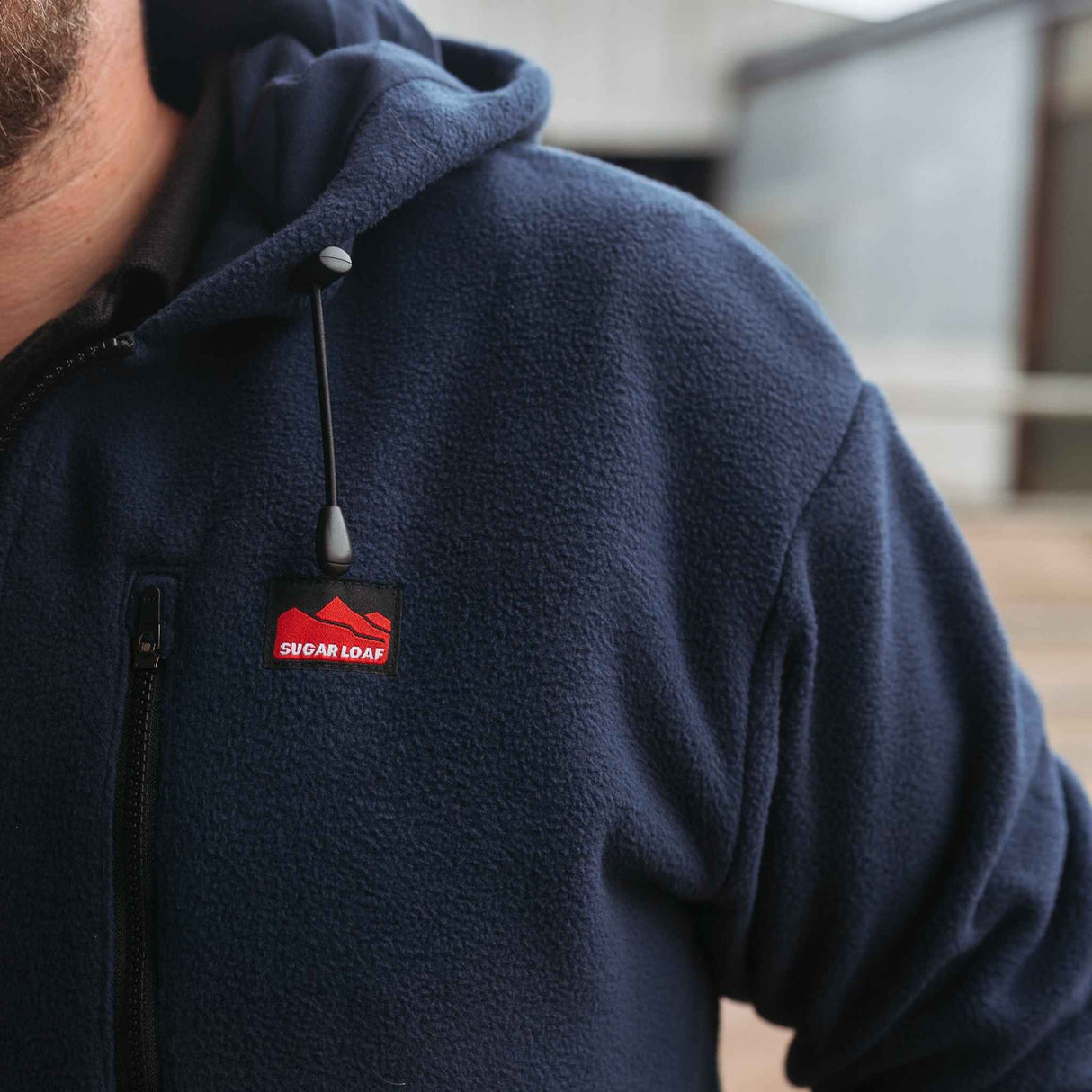 Sugar Loaf Dawnbreaker Polar Fleece Hoodie in Navy Blue close up of logo on chest