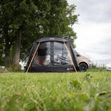 End view of the Vango Sunlight awning pitched on grass beside a campervan