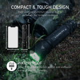 Ledlenser TAC7R torch lying on wet ground shining green light, with a size comparison showing the 15.6cm torch next to a phone