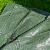 Green S-Grade Tarpaulin 1m x 1m spread on grass, showing the folded sheet and fabric sheen