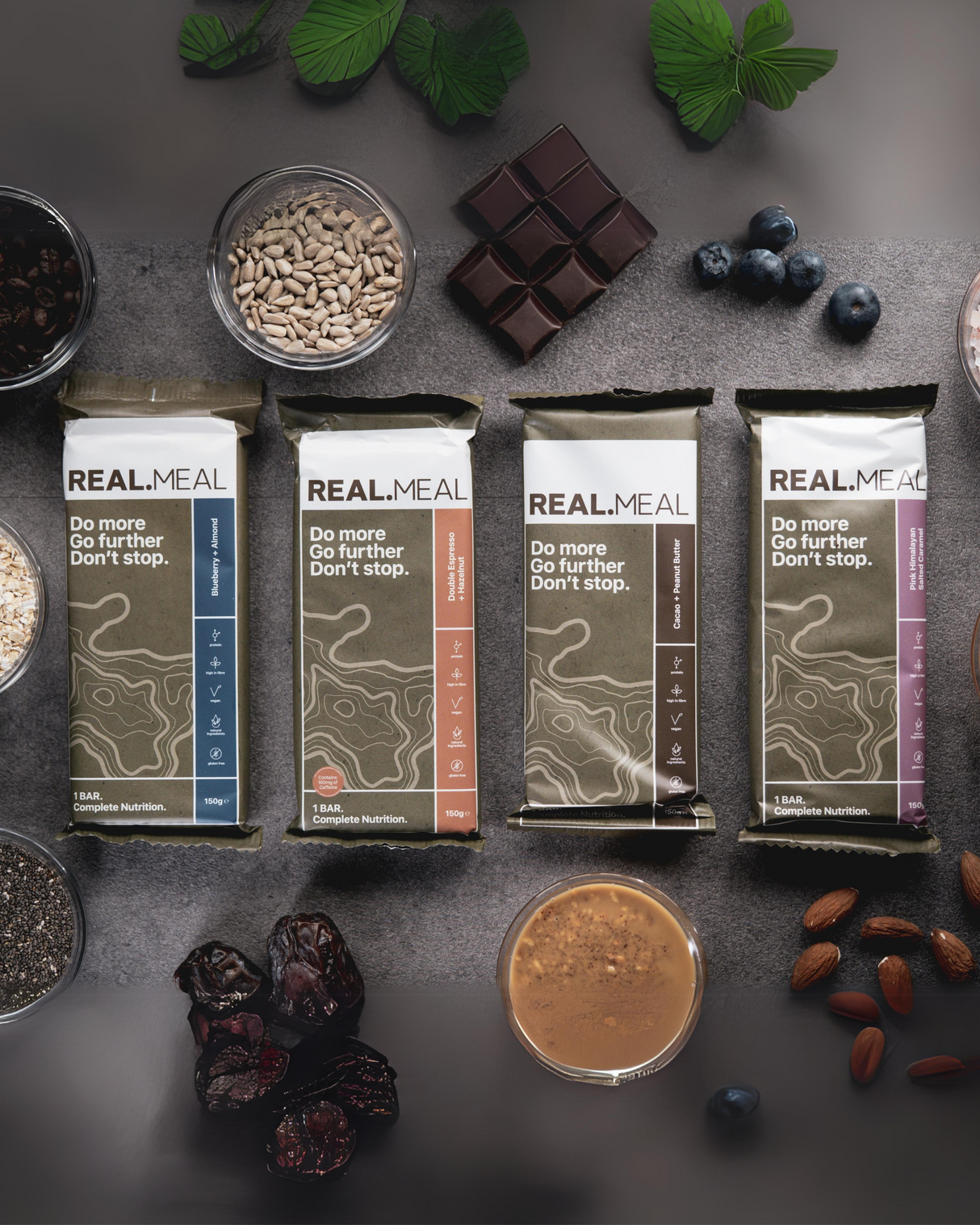 Real Meal Food Bars laid out on the ground with ingredients