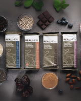 Real Meal Food Bars laid out on the ground with ingredients