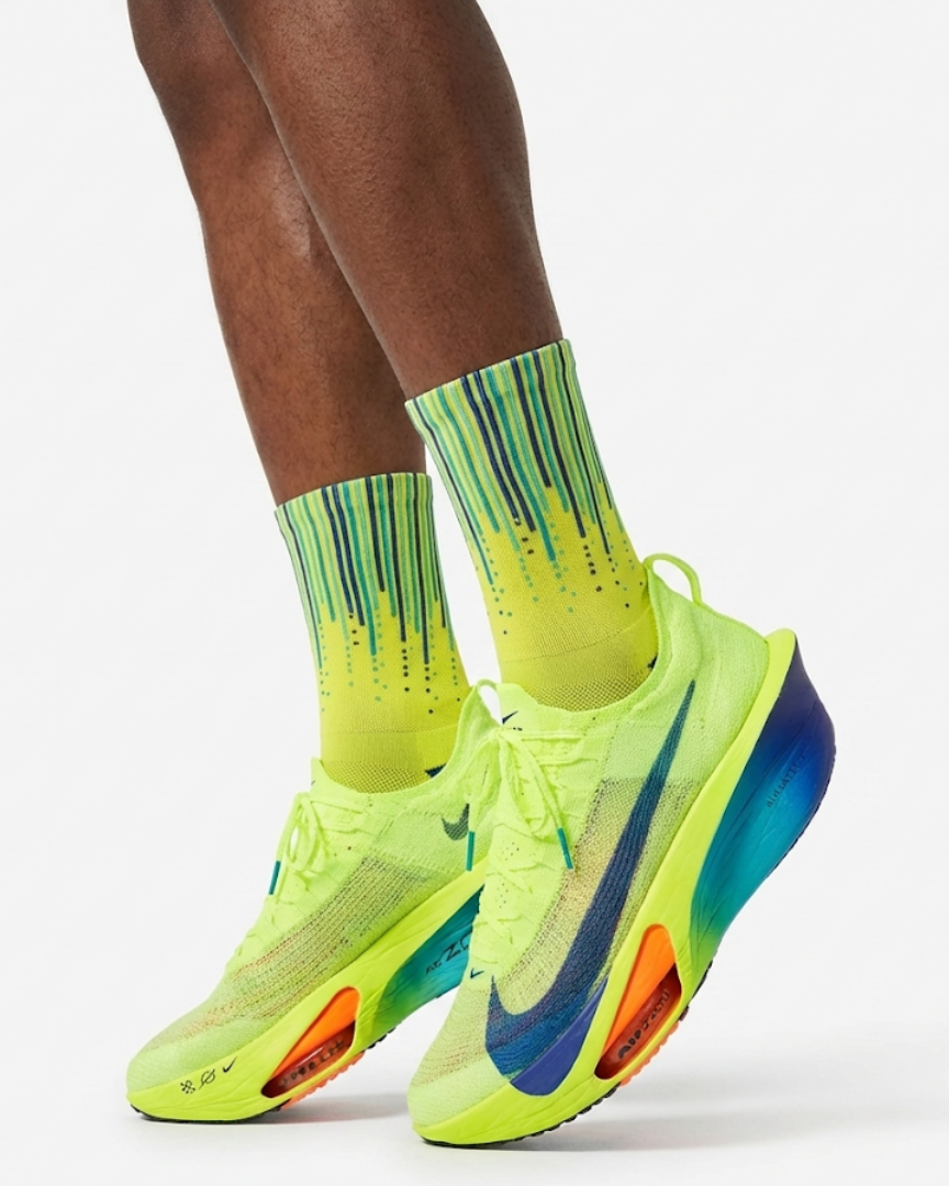 Runner's lower legs in Stride Volt Rush half crew running socks with bright yellow running shoes