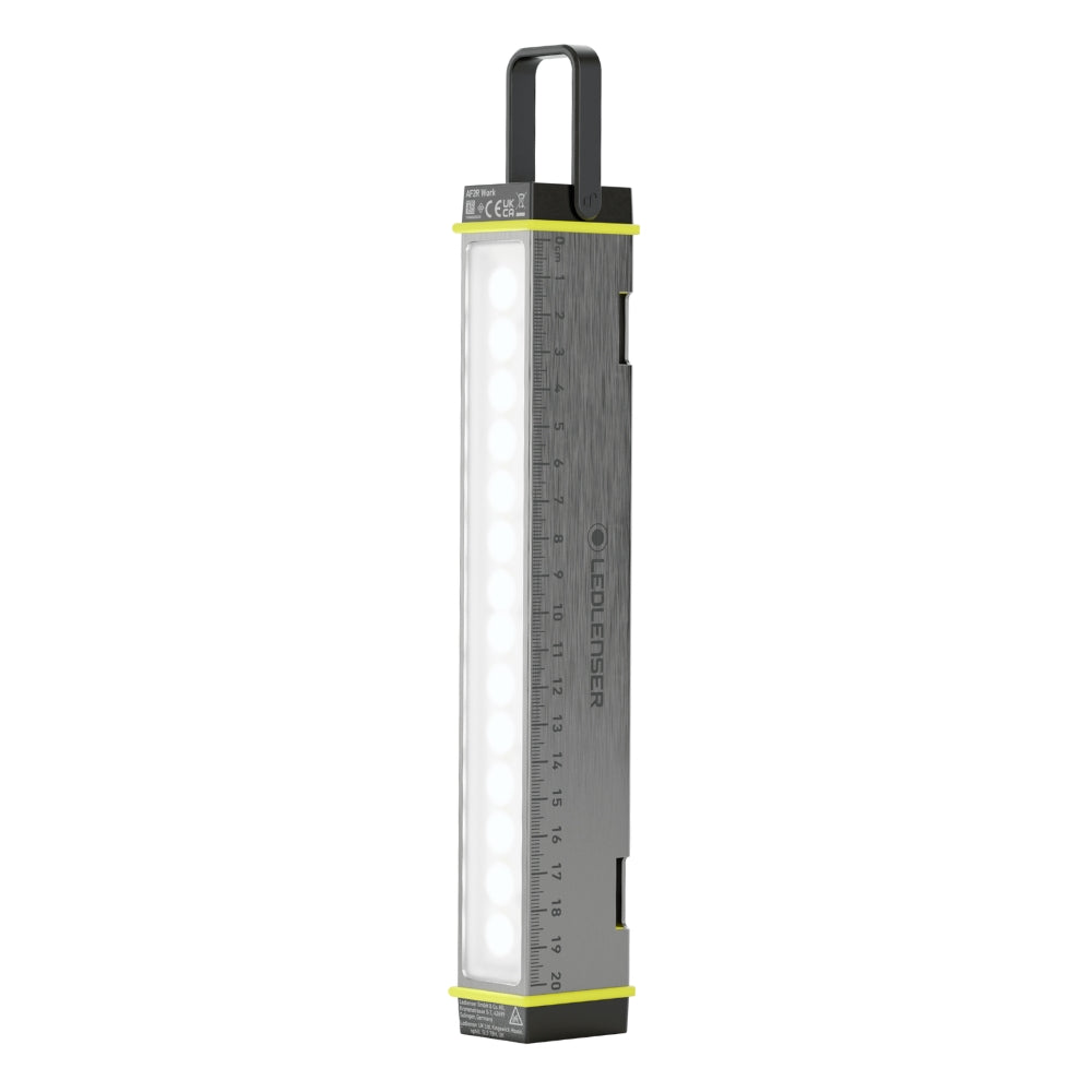 Ledlenser AF2R Work area light standing upright with its rubber hook raised and white LED panel lit