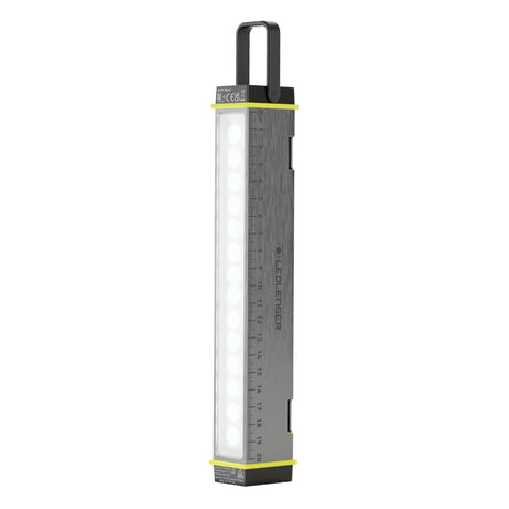 Ledlenser AF2R Work area light standing upright with its rubber hook raised and white LED panel lit
