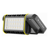 Ledlenser AF4R Work area light angled on its fold-out handle, showing the grid of warm and cool white LEDs