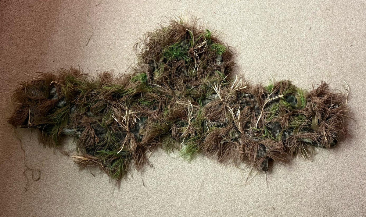 Head and shoulders ghillie suit laid flat, showing the hood and short cape in a dark russet Autumn hessian blend