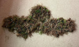 Head and shoulders ghillie suit laid flat, showing the hood and short cape in a dark russet Autumn hessian blend