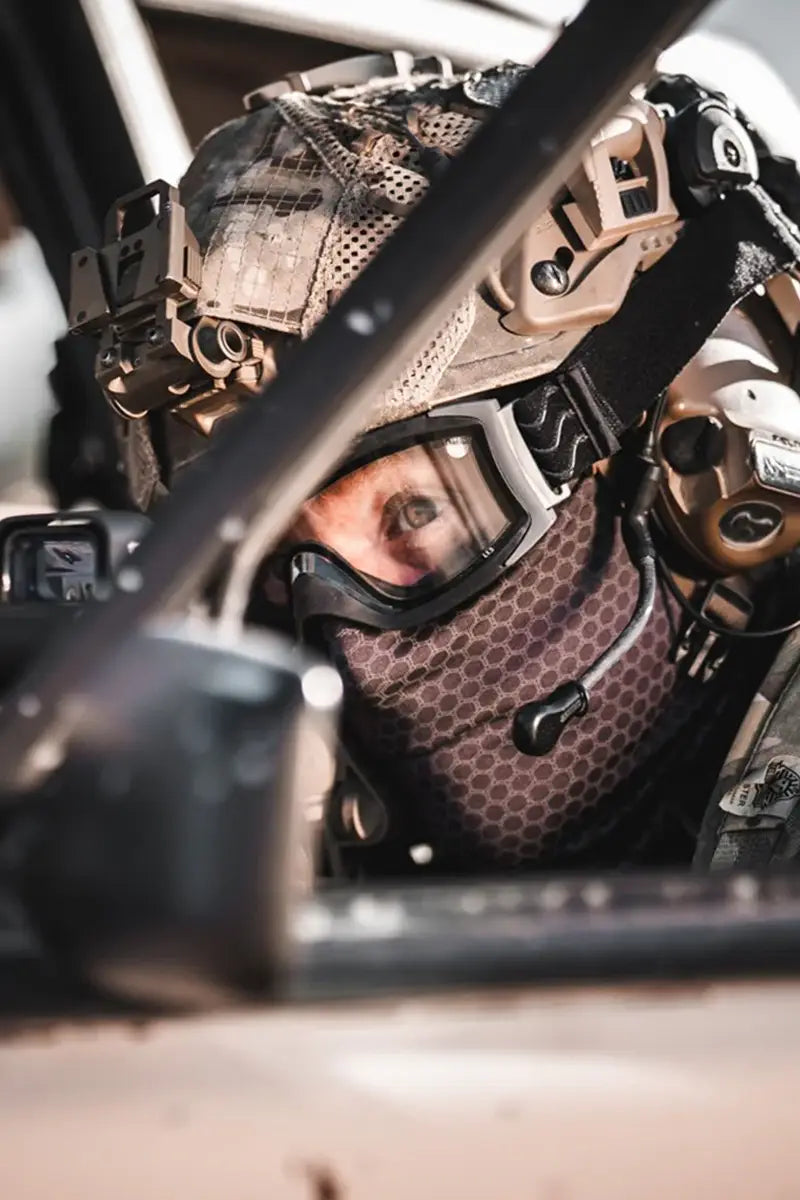 Airsoft Eye Protection - Person wearing tactical goggles in a military-style setting
