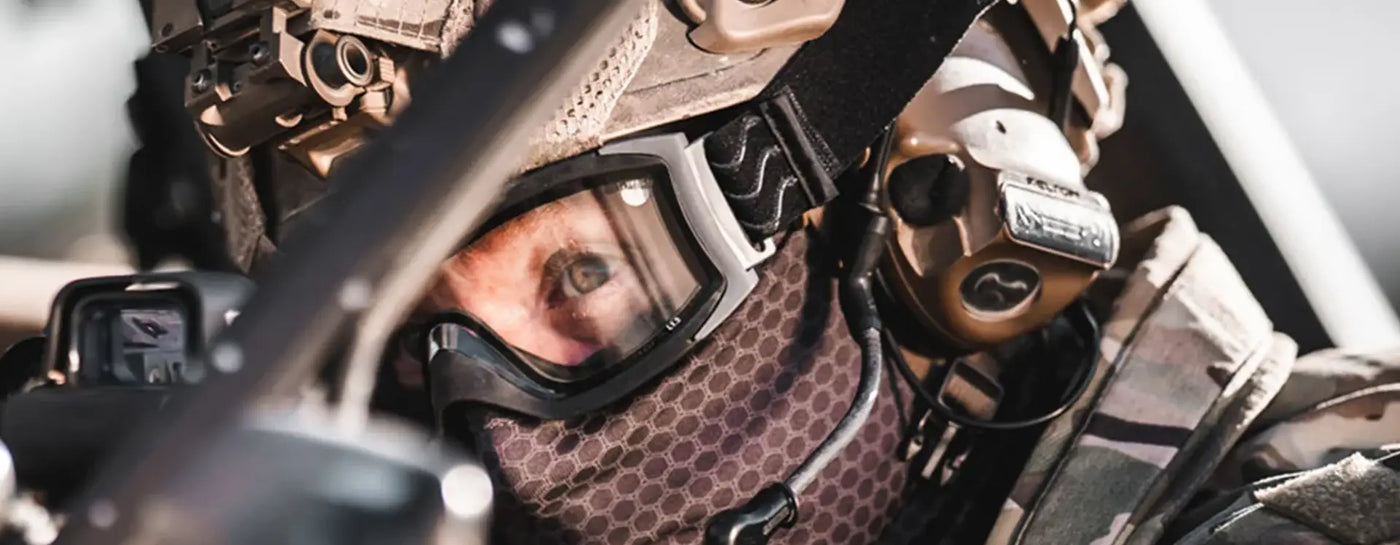 Airsoft Eye Protection - Person wearing tactical goggles in a military-style setting