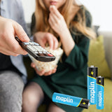 Person holding a TV remote beside Maplin alkaline batteries