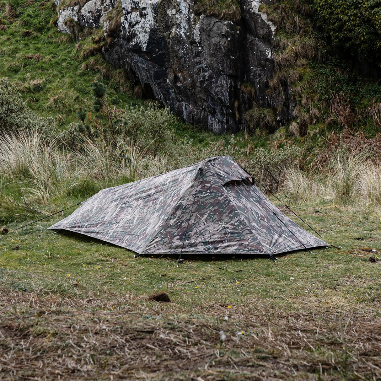 Highlander Blackthorn 1+ Tent Gen2 in HMTC Camo - side view pitched and guyed out in open hillside