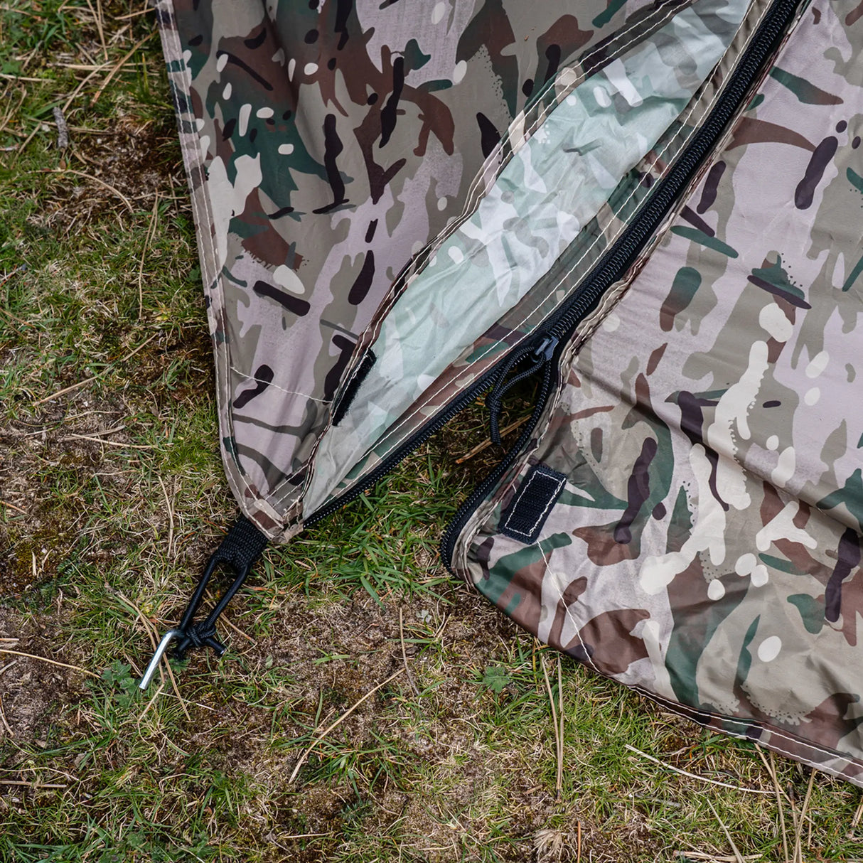 Highlander Blackthorn 1+ Tent Gen2 in HMTC Camo - close-up of flysheet zip pull, peg point and guy line