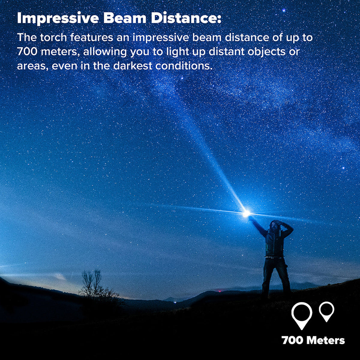 Person on a hillside at night shining the Maplin torch at the starry sky