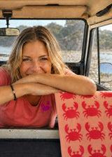 Anorak Crabs Organic Cotton Towel - Coral and blush pink hanging on a campervan