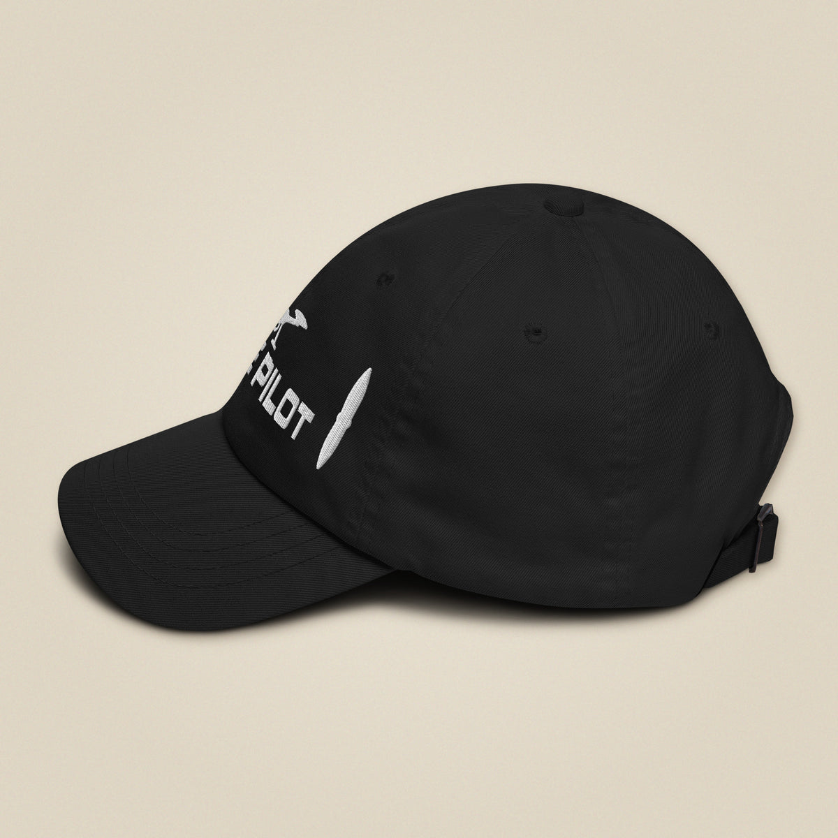 Task "Drone Pilot" cap in Black, side view with the brim to the left, showing the curved peak and the embroidery wrapping round the front