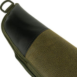 Muzzle end of the green Jack Pyke Duotex Shotgun Slip, black leather cap with a metal D-ring above it