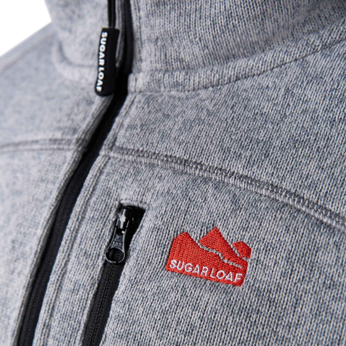 Sugar Loaf Fell Half Zip Fleece Top in Ash Grey close up of logo on chest