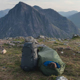 Highlander Hawk Waterproof Bivvy Bag being used outdoors as a shelter - product photograph