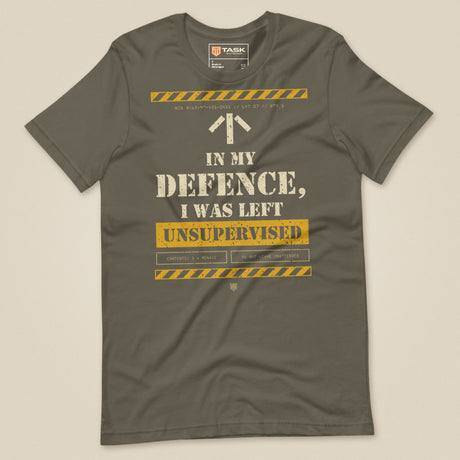 Task "In My Defence, I Was Left Unsupervised" T-shirt in Army, laid flat, front view with distressed stencil slogan and hazard stripes