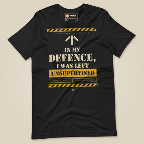 Task "In My Defence, I Was Left Unsupervised" T-shirt in Vintage Black, laid flat, front view