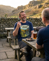 Laughing walker in the It's Just a Bit of a Scramble T-Shirt in Navy showing a grazed knuckle over a pint in a pub garden