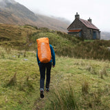 Highlander Ivar Women's Rucksack 50L - Navy Blue with raincover deployed on the trail
