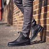 Mongrel K9 Dealer Boot - Black worn leaning against a brick wall