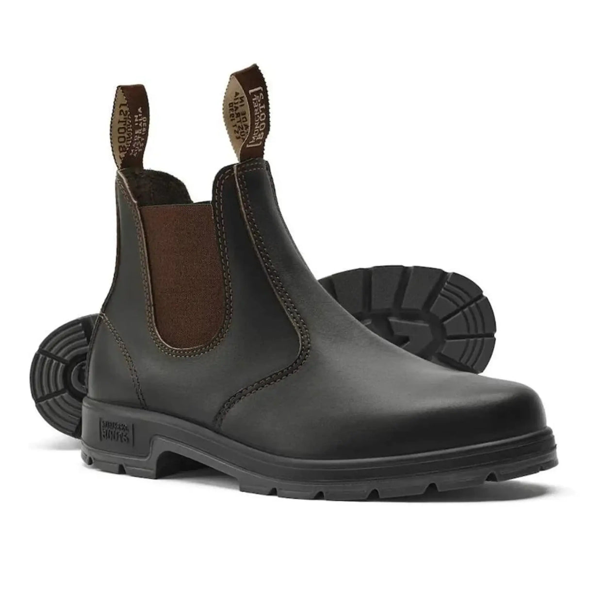 Pair of brown Mongrel K9 dealer boots, one upright and one on its side showing the black cleated outsole