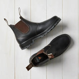 Overhead view of brown Mongrel K9 dealer boots, one flipped to reveal the cushioned insole and Mongrel logo