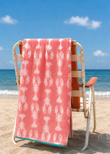 Anorak Lobsters Pink Organic Cotton Towel - Soft pink and white draped over a chair